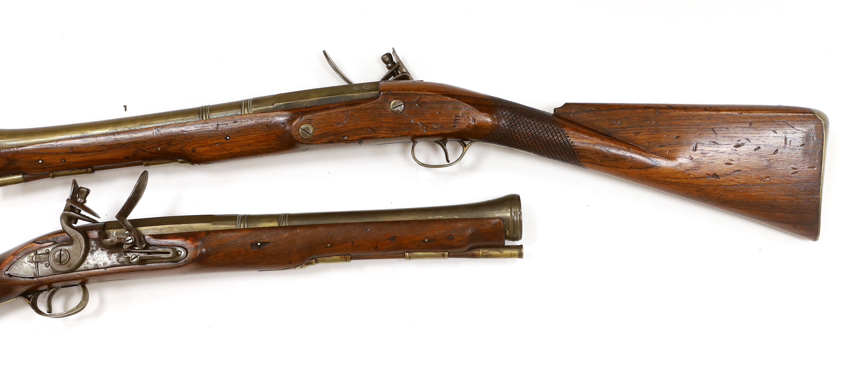 A pair of reproduction 'York Mail' flintlock blunderbusses in a late 18th century style.